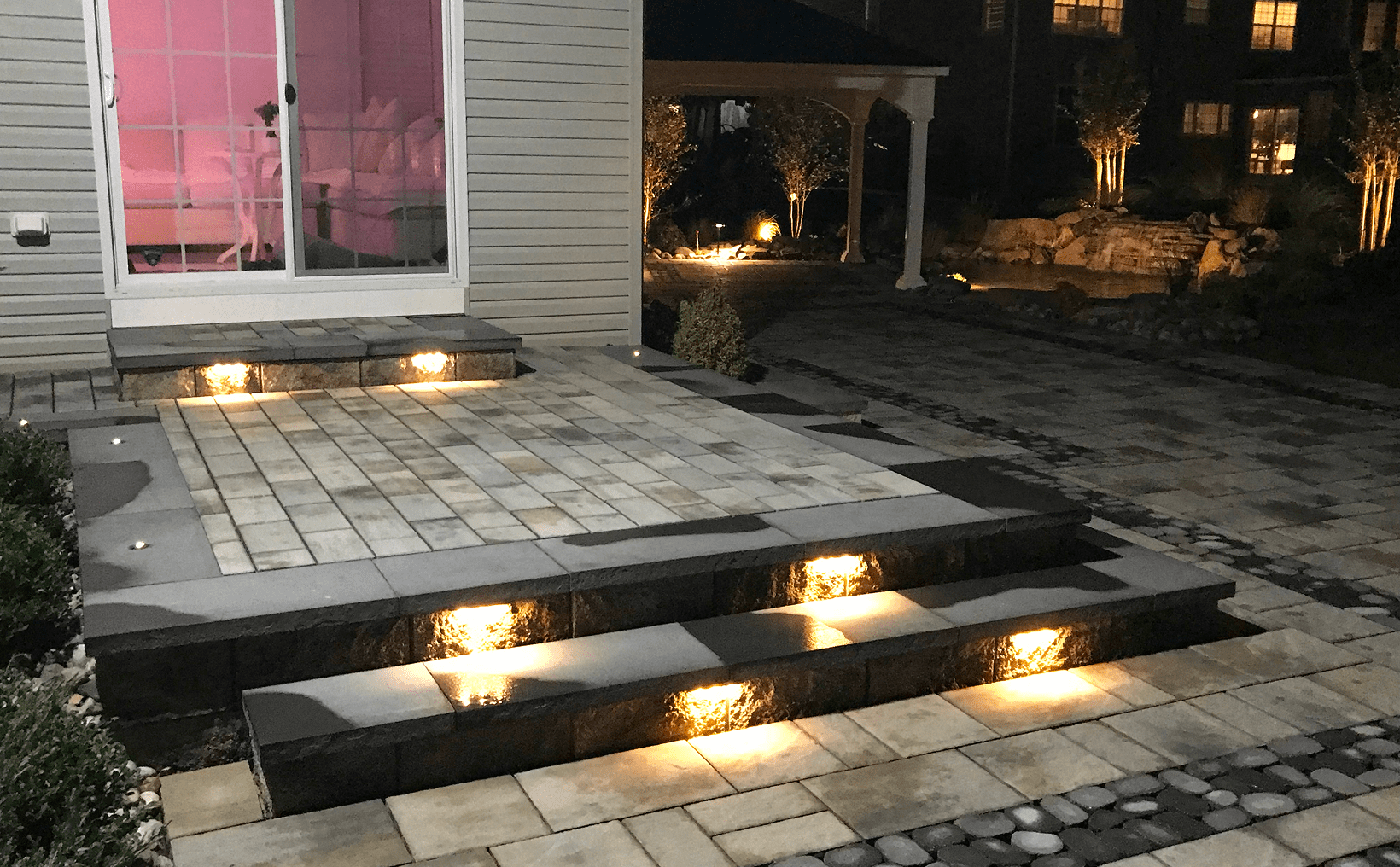 Illuminated patio entrance with steps